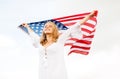 Happy young woman with american flag outdoors