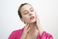 Happy Young Woman Applying Cream on Her Face Royalty Free Stock Photo