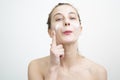 Happy Young Woman Applying Cream on Her Face Royalty Free Stock Photo