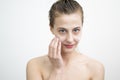 Happy Young Woman Applying Cream on Her Face Royalty Free Stock Photo