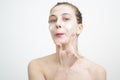 Happy Young Woman Applying Cream on Her Face Royalty Free Stock Photo