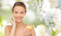 Happy young woman applying cream to her face Royalty Free Stock Photo