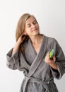 Happy young woman applying hair mask in bathroom Royalty Free Stock Photo