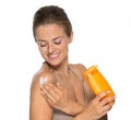 Happy young woman applying sun screen creme Royalty Free Stock Photo