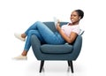 happy young woman in armchair writing to notebook Royalty Free Stock Photo