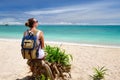 Happy young woman with backpack enjoying view stunning tropical