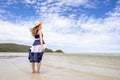 Happy young woman barefoot ware hat and walking on summer along wave of sea water and sand on the beach Royalty Free Stock Photo