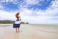 Happy young woman barefoot ware hat and walking on summer along wave of sea water and sand on the beach Royalty Free Stock Photo