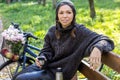 Happy young woman with bicycle relaxing in the park Royalty Free Stock Photo