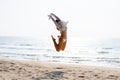 Happy young woman in bikini jumping on the beach Royalty Free Stock Photo
