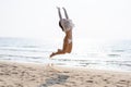 Happy young woman in bikini jumping on the beach Royalty Free Stock Photo