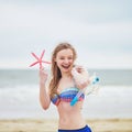 Woman in bikini holding pink starfish Royalty Free Stock Photo