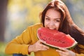 Happy young woman bite slice of ripe watermelon in the park Royalty Free Stock Photo