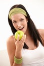 Happy young woman biting apple