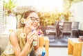 Happy young woman blowing soap bubble in city bar with back sun light - Portrait of cheerful girl having fun outdoor - Happiness, Royalty Free Stock Photo