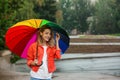 Happy young woman with bright umbrella under rain Royalty Free Stock Photo