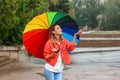 Happy young woman with bright umbrella under rain Royalty Free Stock Photo