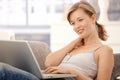 Happy young woman browsing internet at home Royalty Free Stock Photo