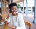 Happy young woman calling by mobile phone at restaurant Royalty Free Stock Photo