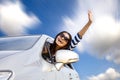 Happy young woman in car driving