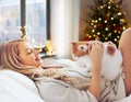 Happy young woman with cat in bed at home Royalty Free Stock Photo