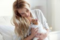 Happy young woman with cat in bed at home Royalty Free Stock Photo