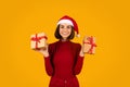 Happy young woman celebrating xmas, showing her presents