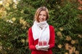 Happy young woman with Christmas gift box on hands with golden lightning bokeh Royalty Free Stock Photo