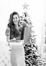 Happy young woman christmas present boxes in front of christmas Royalty Free Stock Photo