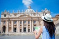 Happy young woman with city map in Vatican city and St. Peter's Basilica church, Rome, Italy. Travel tourist woman with Royalty Free Stock Photo