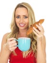 Happy Young Woman With Coffee and Croissant Royalty Free Stock Photo