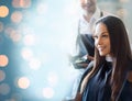 Happy young woman coloring hair at salon