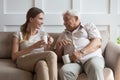 Happy young woman communicating with smiling old father. Royalty Free Stock Photo