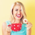 Happy young woman with cookie and coffee Royalty Free Stock Photo