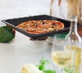 Happy young woman cooking pizza at home Royalty Free Stock Photo