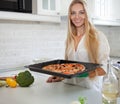 Happy Young Woman Cooking Pizza at Home Royalty Free Stock Photo