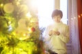 Happy young woman with cup of coffee or tea at home over christmas tree Royalty Free Stock Photo