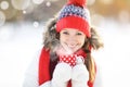 Happy young woman with a cup of hot tea in winter walk Royalty Free Stock Photo