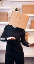 Happy young woman dancing with a cardboard box over her head. Relocation and purchase of real estate Royalty Free Stock Photo