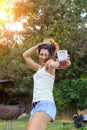 Happy young woman dancing and having fun at summer party at sunset. Royalty Free Stock Photo