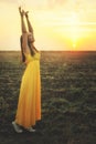 Happy young woman dancing and praising nature.