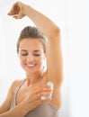 Happy young woman deodorant on underarm Royalty Free Stock Photo