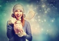 Happy young woman depositing money into her piggy bank Royalty Free Stock Photo