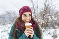 Happy young woman with disposable cup of coffee or tea wearing warm clothing. Beautiful girl holding disposable cup,standing Royalty Free Stock Photo