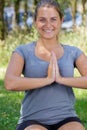 Happy young woman doing yoga outdoors Royalty Free Stock Photo