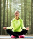 Happy young woman doing yoga outdoors Royalty Free Stock Photo