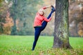 Happy young woman doing yoga in park Royalty Free Stock Photo