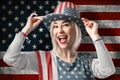 Independence Day. Happy young woman dressed in american flag clothes on american flag background Royalty Free Stock Photo