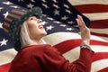 Independence Day. Happy young woman dressed in american flag clothes on american flag background Royalty Free Stock Photo