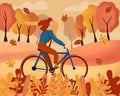 Happy young woman dressed in autumn clothes riding a bicycle with forest background. Leaves flying around in wind